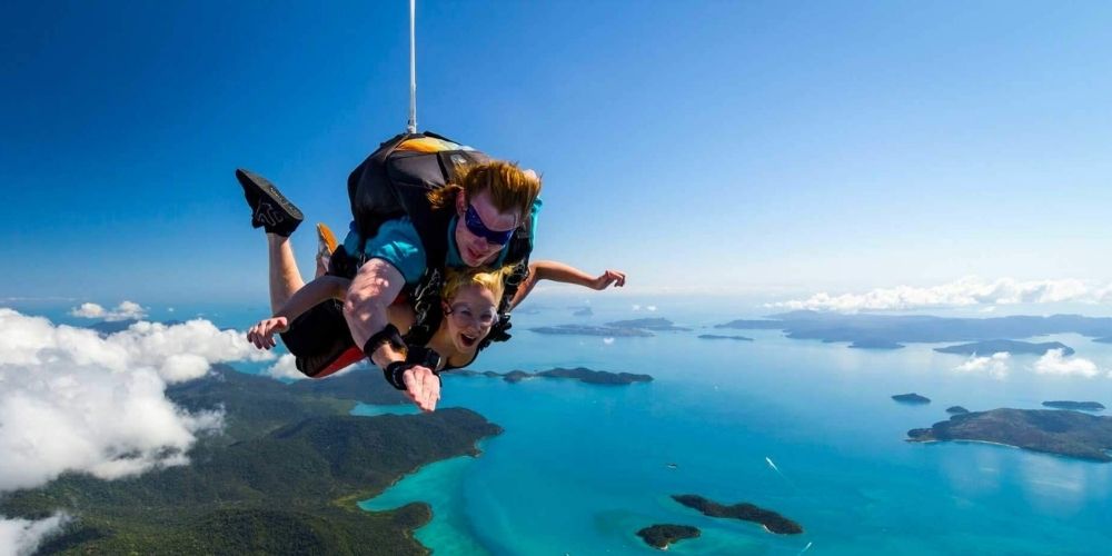Where to skydive in Brisbane. couple high in the sky skydiving